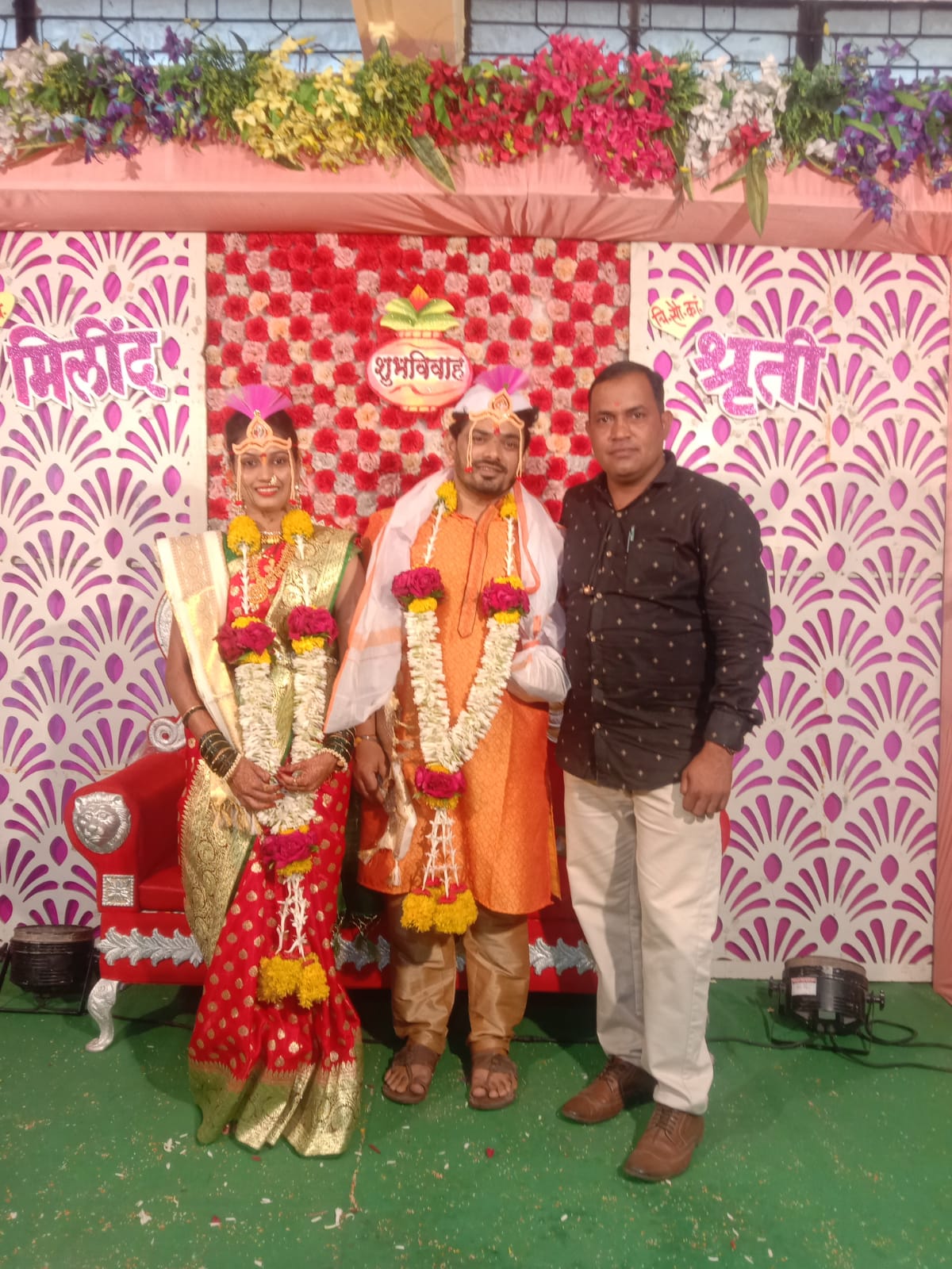 Happy Indian bride and groom in traditional wedding attire posing together